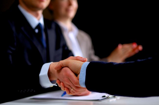 Business people shaking hands, finishing up a meeting .